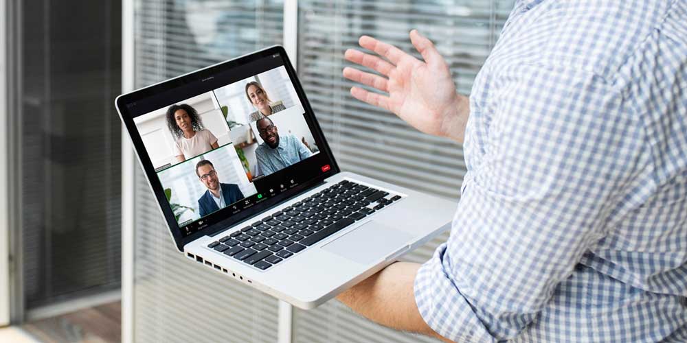 Employee having a remote conference call on his laptop