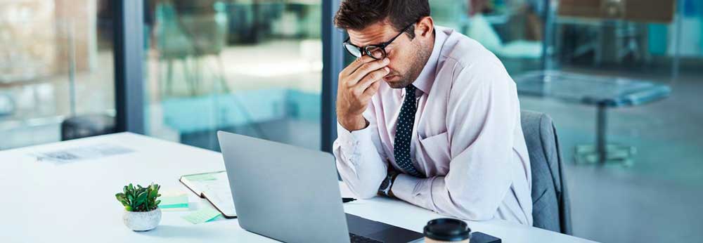 Overworked employee sitting in his desk