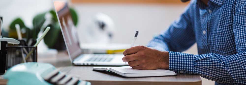 Employee writing down his workday schedule