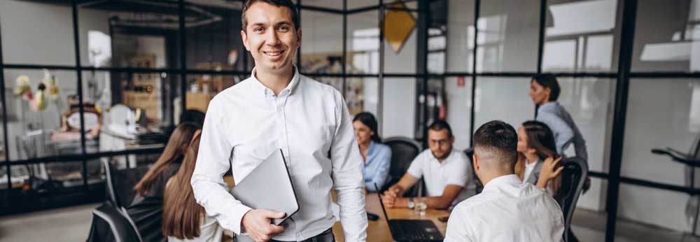 Business owner with group of employees in background