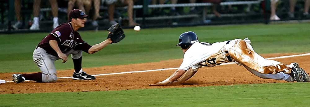 a baseball player sliding into home plate