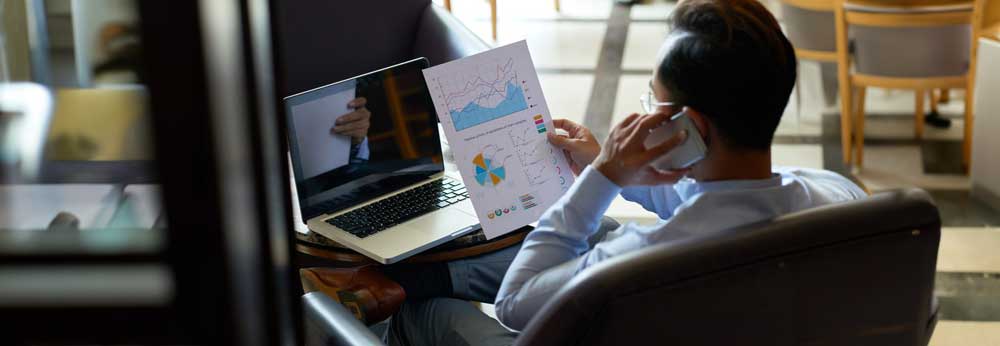 Employee working from home looking at a page with charts